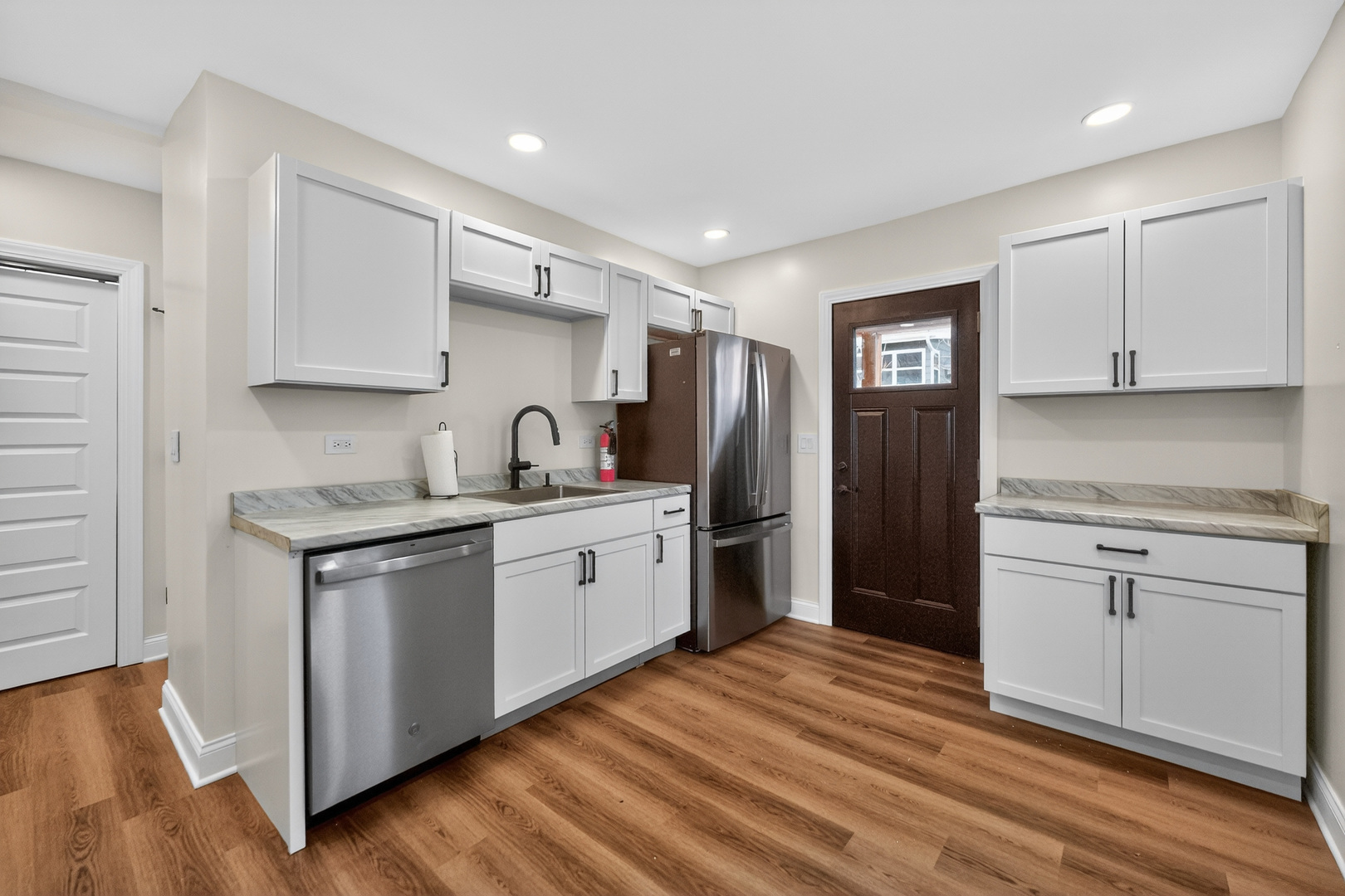 305 West Exchange Street, Unit A Sycamore, IL 60178 - Photo 9 of 27 a kitchen with stainless steel appliances granite countertop a sink stove and refrigerator