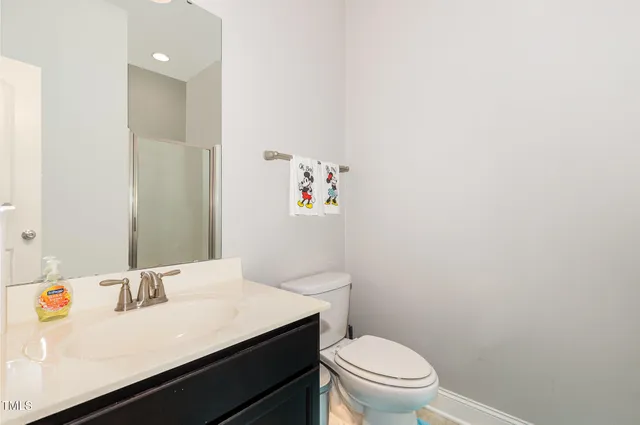 a bathroom with a sink a toilet and vanity