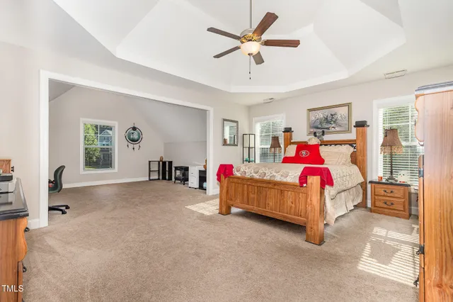 a bedroom with a bed and a chandelier