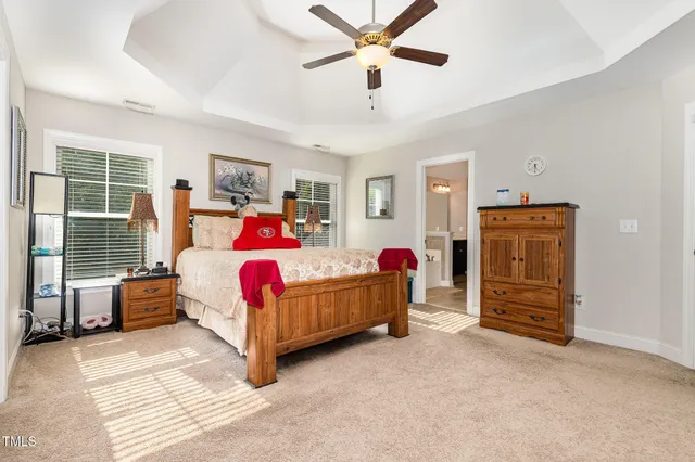 a bedroom with a bed dresser and a window