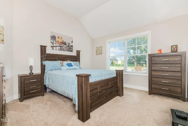a bedroom with a bed and a dresser