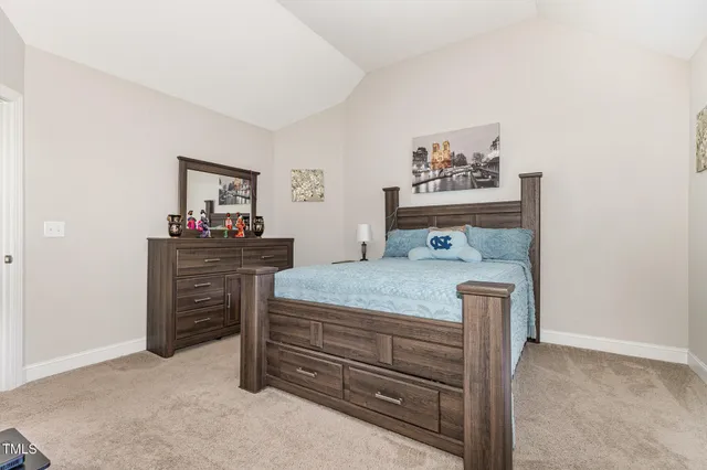 a bedroom with a bed table and window