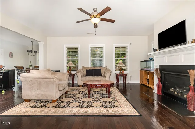 a living room with a couch a flat screen tv and a fireplace