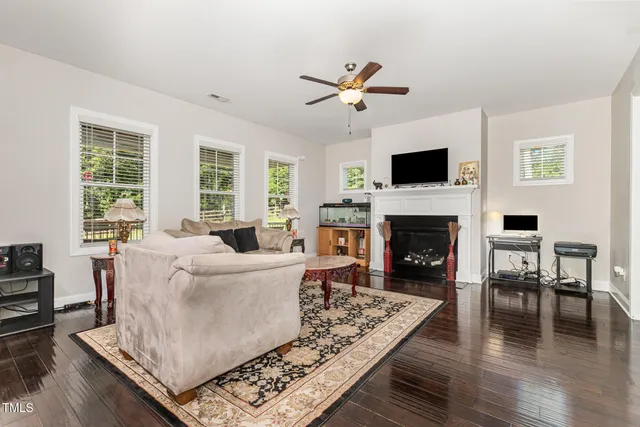 a living room with furniture a fireplace and a flat screen tv