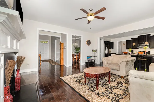 a living room with furniture a rug and a dining table