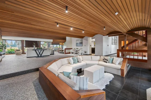 a view of kitchen island with granite countertop lots of clutter and stainless steel appliances
