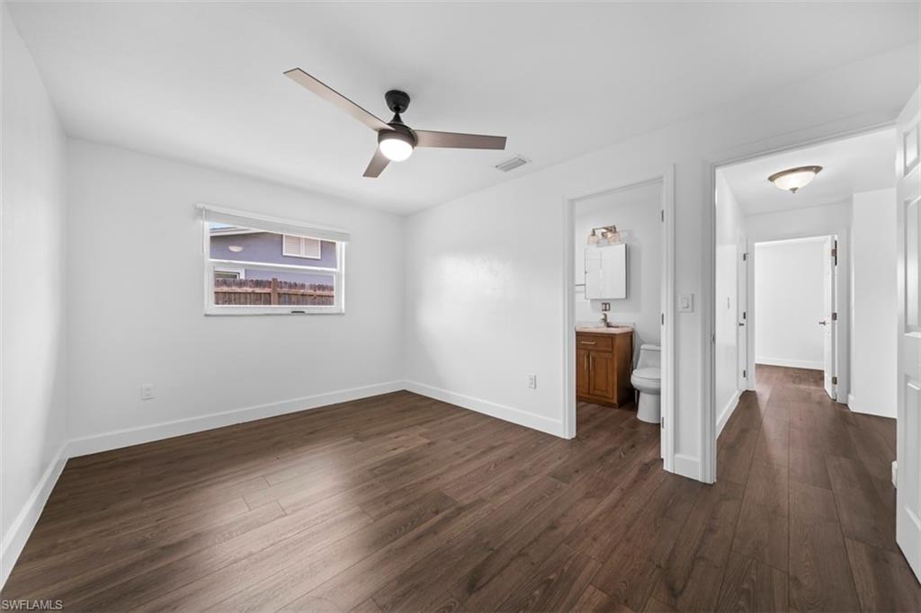 5460 Bayshore Road North Fort Myers, FL 33917 - Photo 6 of 14 a view of a big room with wooden floor a ceiling fan and windows