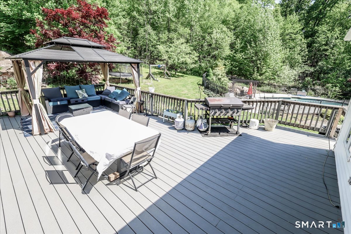 55 A Flax Hill Road Brookfield, CT 06804 - Photo 7 of 40 a view of a patio with wooden floor table and chairs
