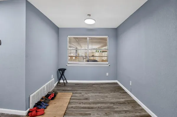 a very nice looking room with wooden floor and a window