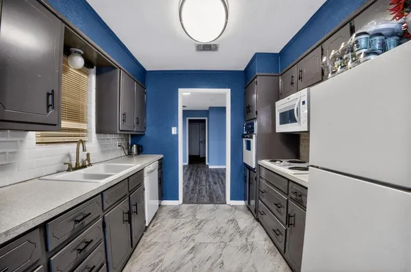 a kitchen with a sink stove and cabinets