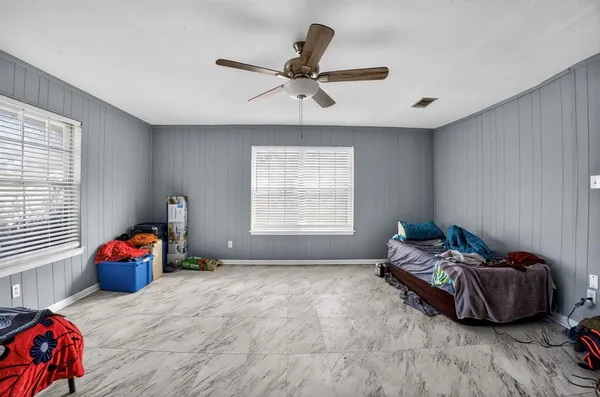 a bedroom with furniture and a window