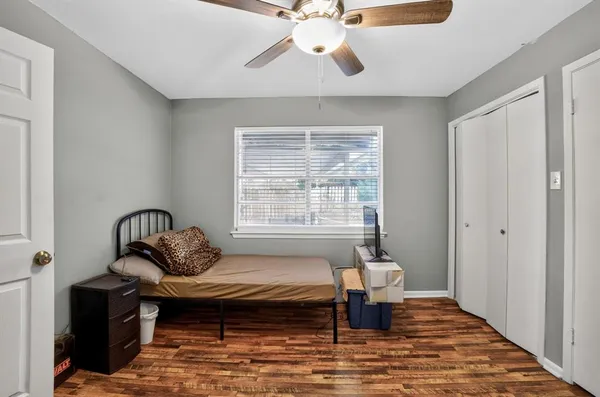 a bedroom with a bed and a window