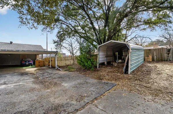 a view of a house with a yard and tree s