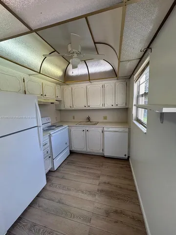 a kitchen with cabinets a sink and dishwasher