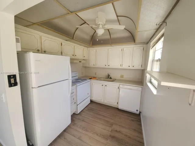 a white refrigerator freezer sitting inside of a kitchen
