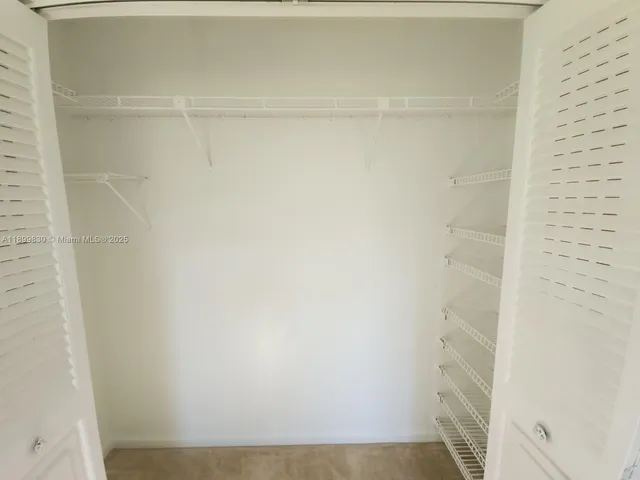 a view of a room with a ceiling fan
