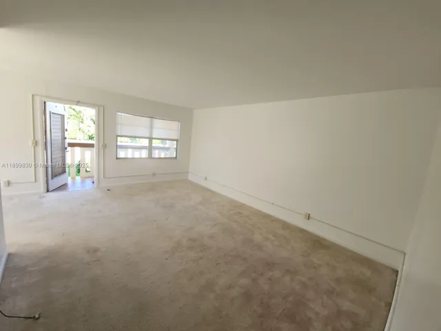 a view of an empty room with windows