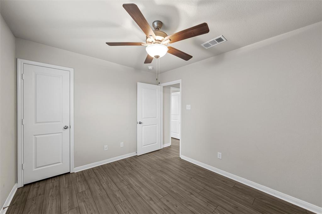 3208 Dottavio Road Lorena, TX 76655 - Photo 19 of 31 Interior room with wood-finish flooring, light gray wall paint, and white baseboards
