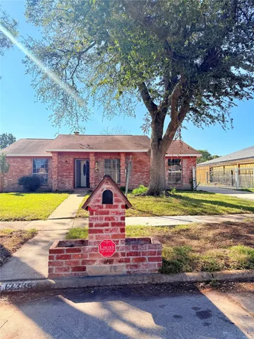 a front view of house with yard and trees