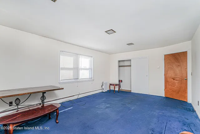 a living room with furniture a rug and a window