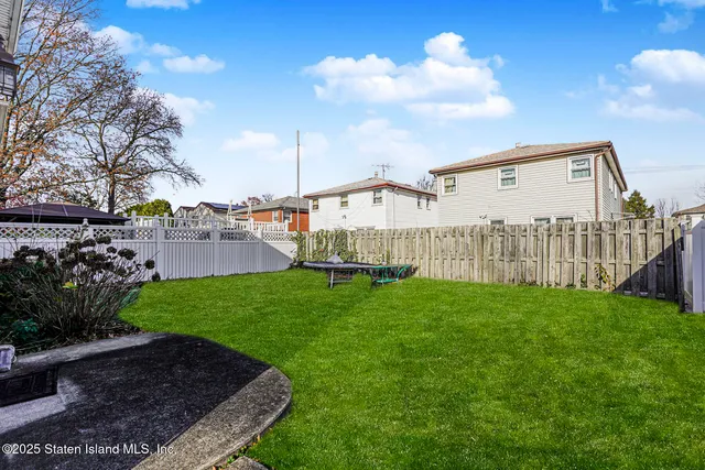 a large kitchen with stainless steel appliances granite countertop a refrigerator and a sink
