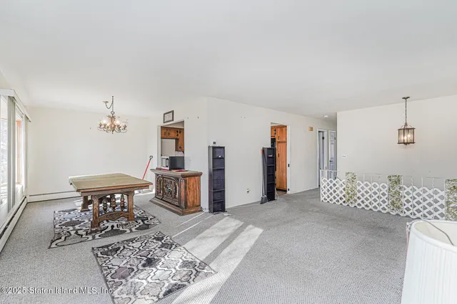 an empty room with closet and windows