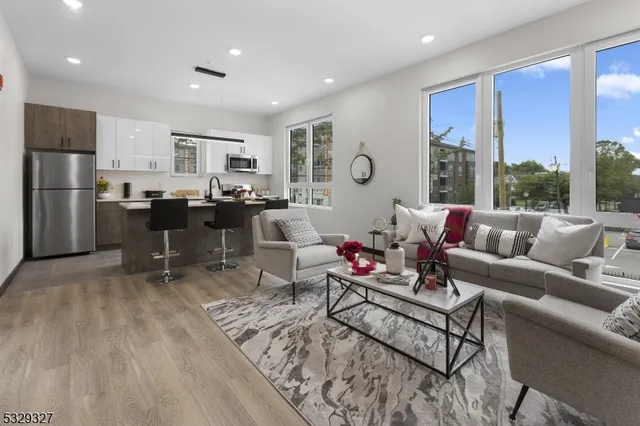 a living room with furniture wooden floor and a table