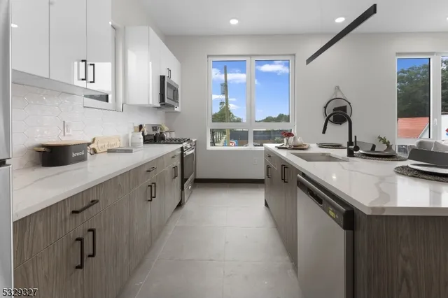 a kitchen with a sink cabinets and a stove