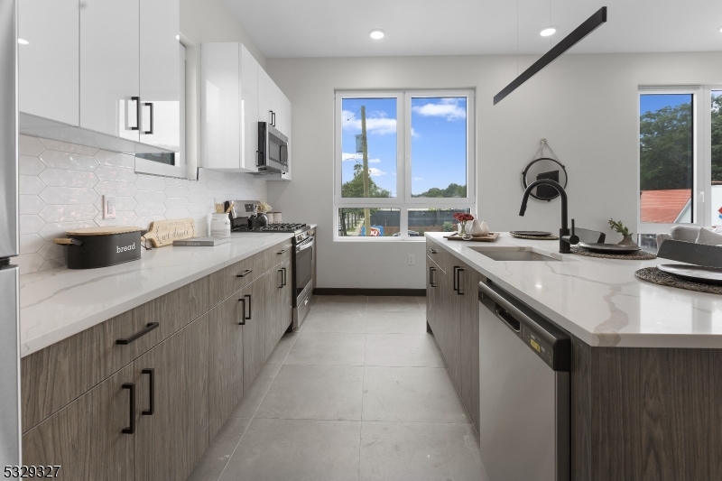 1369 South Avenue, Unit 5 Plainfield, NJ 07062 - Photo 8 of 11 a kitchen with a sink cabinets and a stove