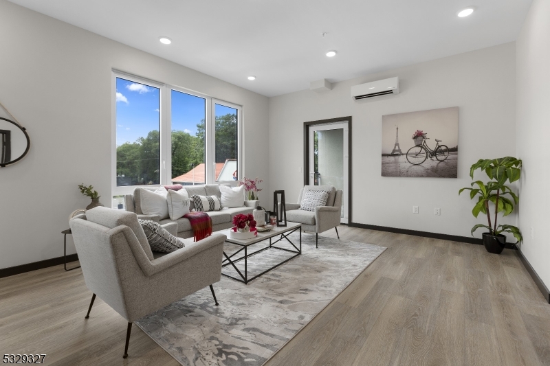 1369 South Avenue, Unit 5 Plainfield, NJ 07062 - Photo 10 of 11 a living room with furniture floor to ceiling window and potted plant