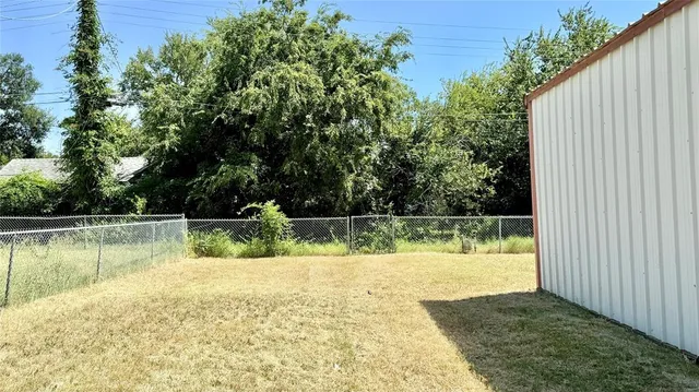 a view of a swimming pool with a yard