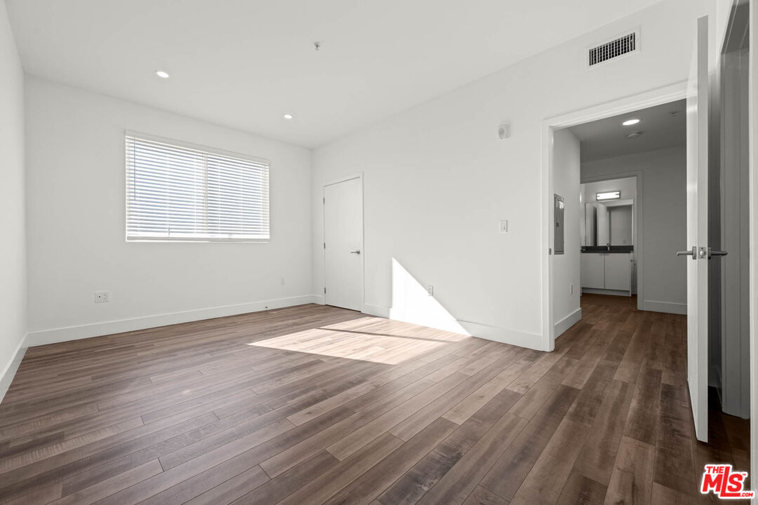 1215 South Bedford Street, Unit 105 Los Angeles, CA 90035 - Photo 12 of 27 a view of empty room with wooden floor