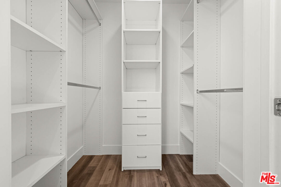 1215 South Bedford Street, Unit 105 Los Angeles, CA 90035 - Photo 18 of 27 a view of walk in closet with wooden floor