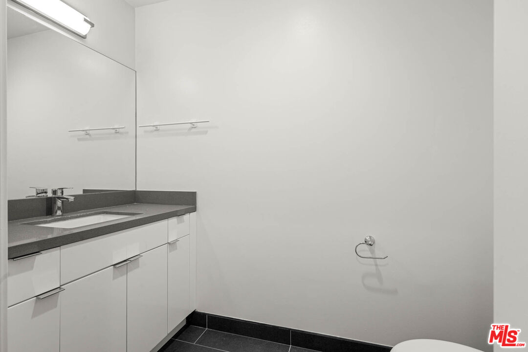 1215 South Bedford Street, Unit 105 Los Angeles, CA 90035 - Photo 20 of 27 a bathroom with a sink and vanity
