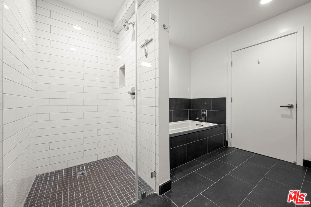 1215 South Bedford Street, Unit 105 Los Angeles, CA 90035 - Photo 22 of 27 a bathroom with a sink and a shower