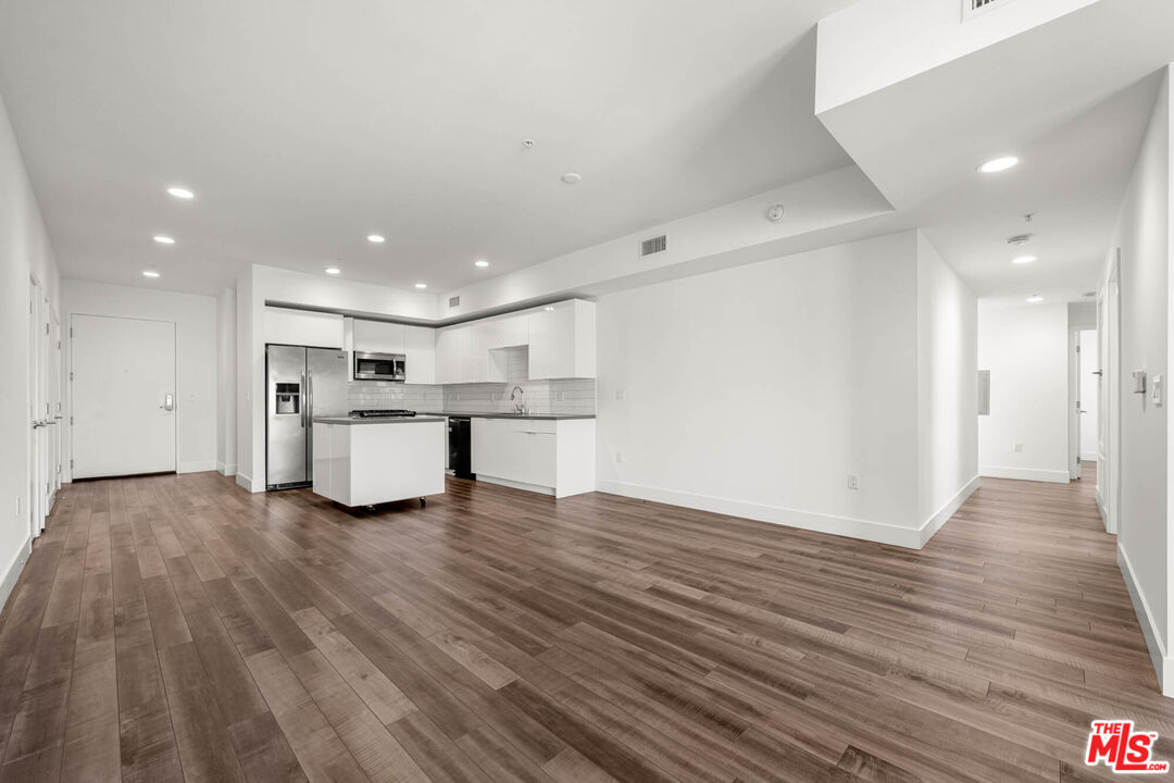1215 South Bedford Street, Unit 105 Los Angeles, CA 90035 - Photo 7 of 27 a view of kitchen with wooden floor
