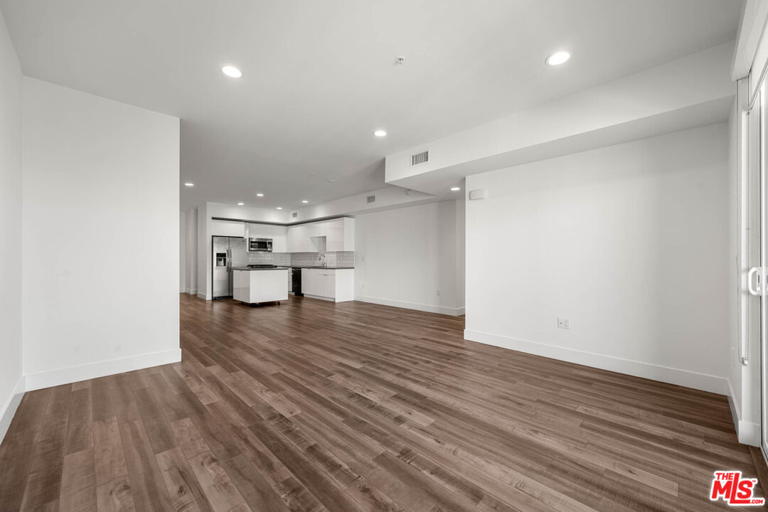 1215 South Bedford Street, Unit 105 Los Angeles, CA 90035 - Photo 8 of 27 a view of empty room with wooden floor