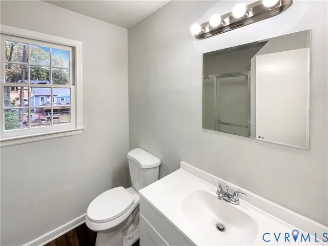 a bathroom with a sink mirror and toilet
