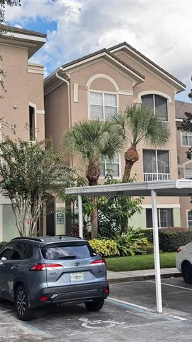 a car parked in front of a white building