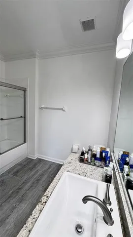 a bathroom with a granite countertop sink mirror and toilet