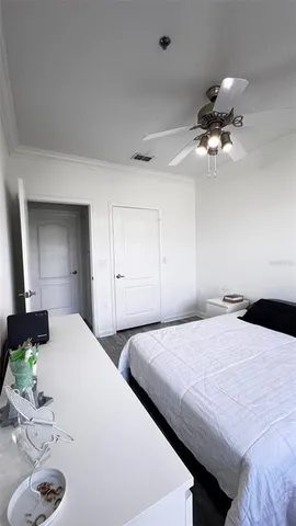 a bedroom with a bed and a chandelier