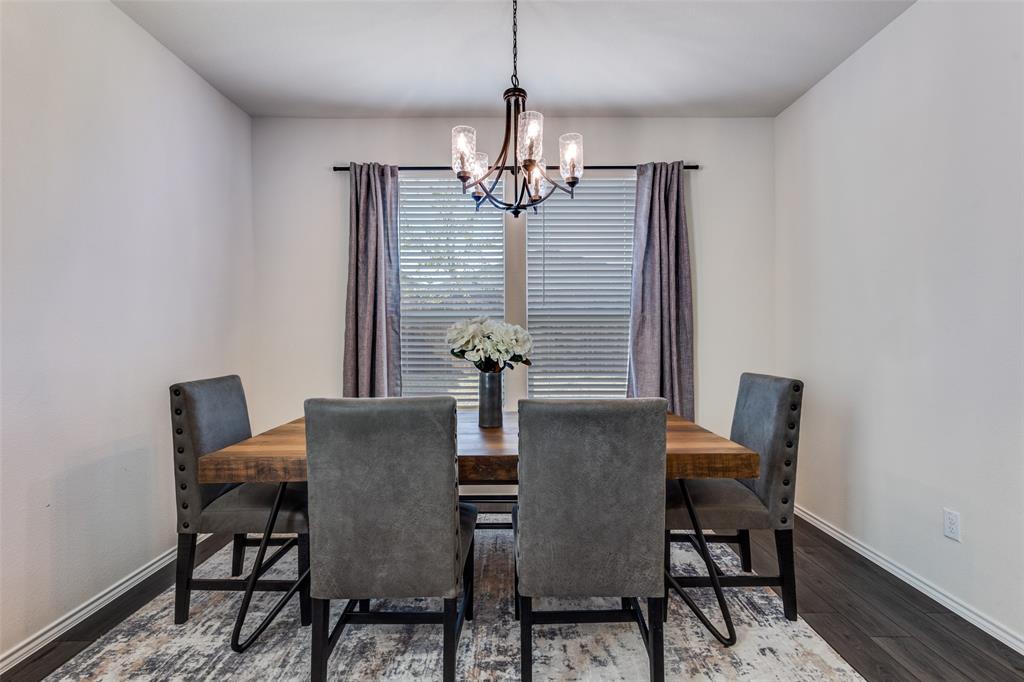 1810 Hummingbird Street Princeton, TX 75407 - Photo 14 of 25 a dining room with furniture and chandelier