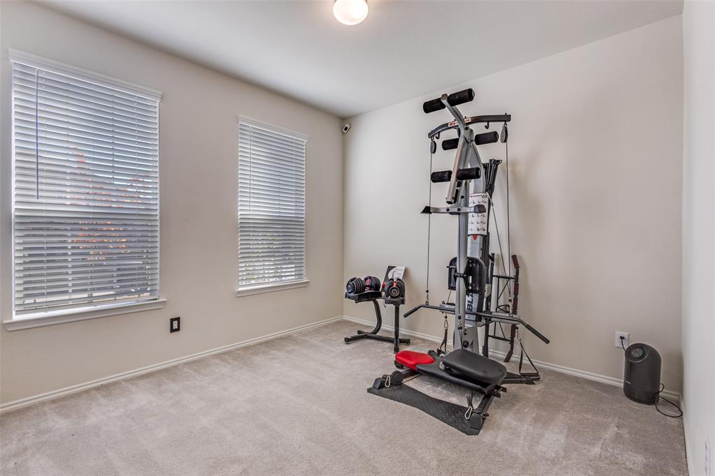 1810 Hummingbird Street Princeton, TX 75407 - Photo 19 of 25 a view of a room with gym equipment and windows