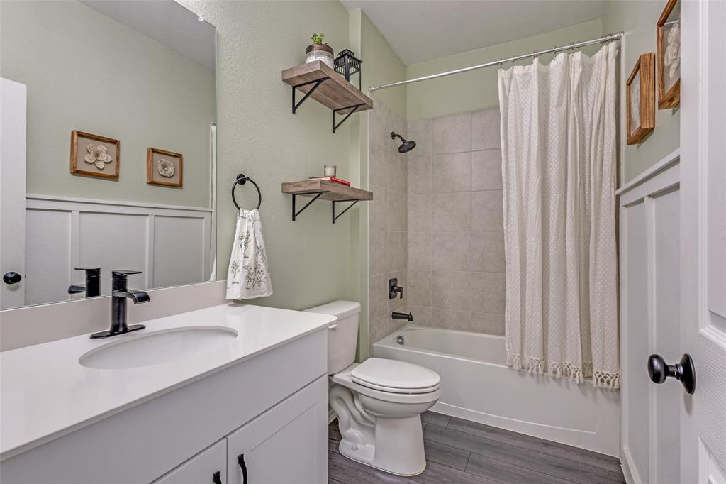 1810 Hummingbird Street Princeton, TX 75407 - Photo 20 of 25 a bathroom with a sink a toilet and shower