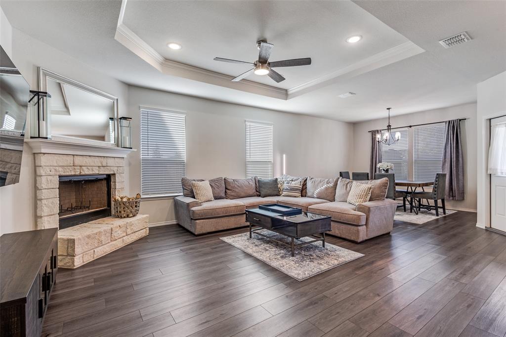 1810 Hummingbird Street Princeton, TX 75407 - Photo 5 of 25 a living room with furniture fireplace and wooden floor