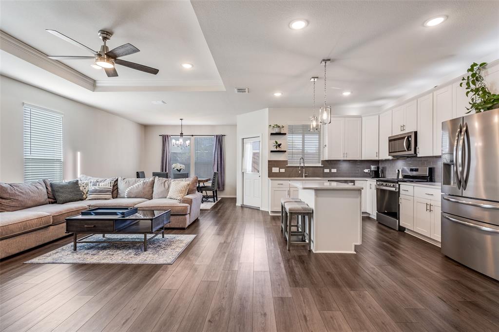 1810 Hummingbird Street Princeton, TX 75407 - Photo 7 of 25 a living room with furniture appliances and wooden floor