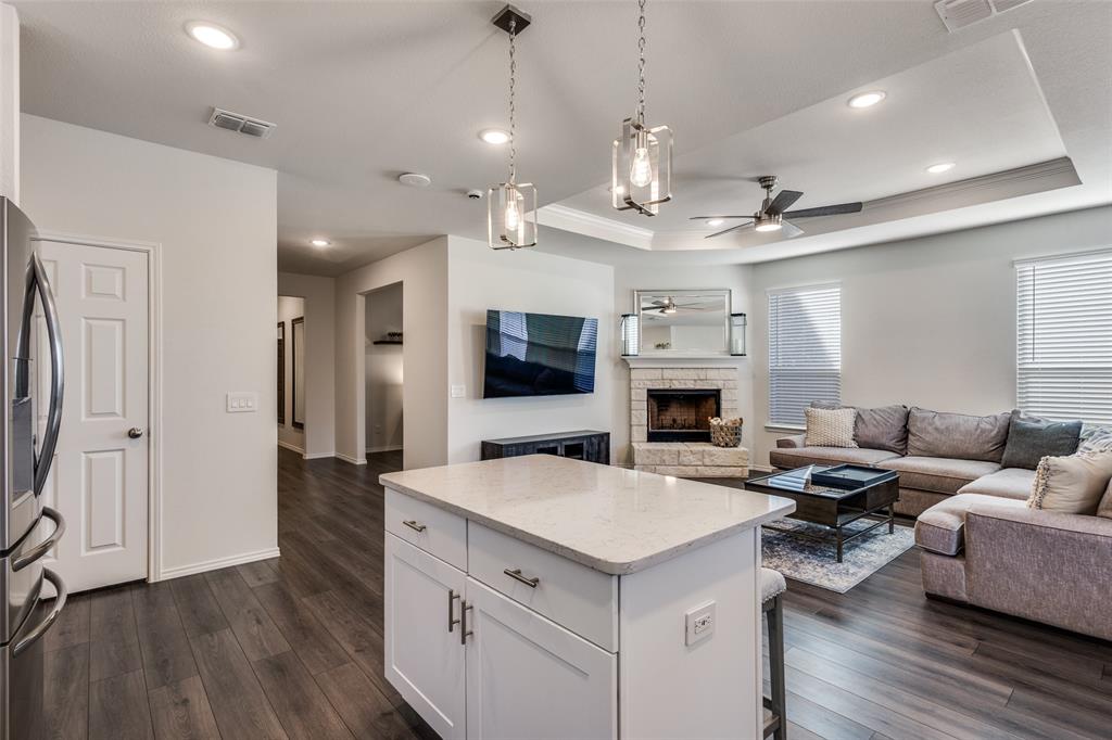 1810 Hummingbird Street Princeton, TX 75407 - Photo 10 of 25 a view of living room kitchen with stainless steel appliances kitchen island a flat screen tv and a couch