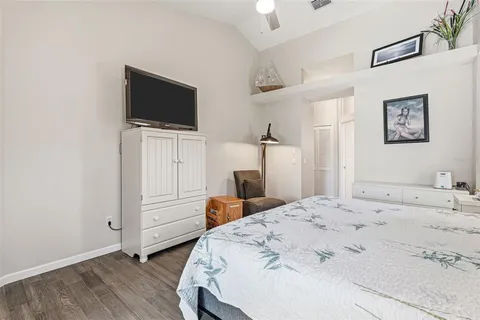 a bedroom with a bed and a painting on the wall