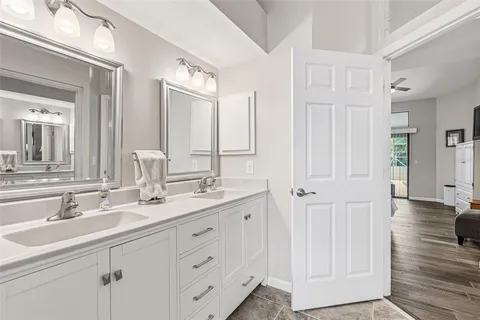 a bathroom with a sink toilet a mirror and shower