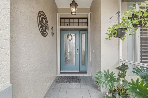a living room with furniture a flat screen tv and kitchen view